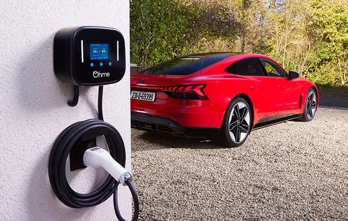 Ohme Home Pro EV charger installed on white wall charging red Audi electric car in UK driveway